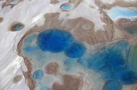 Aerial view of silt and turquoise water in an Alaska glacier, Alaska