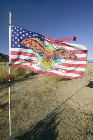 Native American Indian flag blows in wind on Chumash Indian land on highway 33, near Cuyama Californiaのeditorial素材