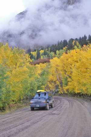 Autumn Aspens and clouds at the Kebbler Pass in Gunnison National Forest, Coloradoのeditorial素材