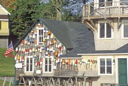 Floats from fishing nets hang on the side of a lighthouse in Stonington, Mount Desert Island, Maineのeditorial素材