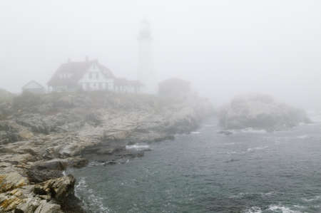 Fog shrouds the Portland Head Lighthouse in Cape Elizabeth, Maineのeditorial素材