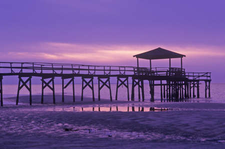 Sunrise over the Gulf of Mexico with pier in Biloxi, MSのeditorial素材