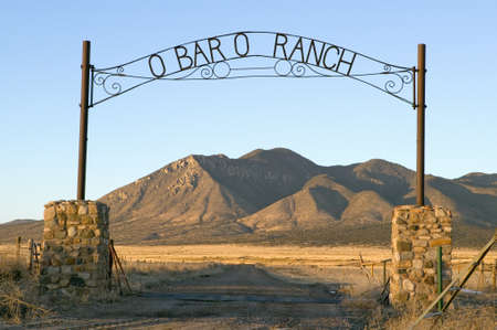 O'Bar'o Ranch gate and mountains at sunset in central New Mexico, Route 48 near Smokey Bear Historical Parkのeditorial素材