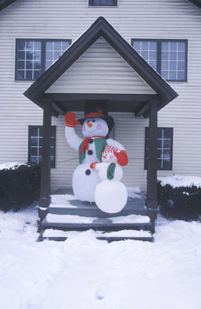 Frosty the snowman after winter snow in New Jersey during Christmas celebration in front doorway of homeのeditorial素材