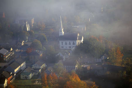 Aerial view of Waitsfield, VT in fog with church steeple on Scenic Route 100 in Autumnのeditorial素材