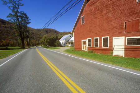 Red barn by side of Scenic Route 100 in autumn, VTのeditorial素材