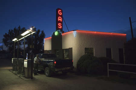Neon sign reading Gas as gas attendant fills truck with gasoline at Kensinger Service & Supply historic gas station, on US Highway 30, the Lincoln Highway, Grand Island, Nebraskaのeditorial素材