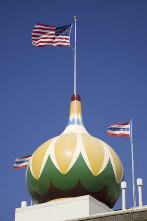 Main Street view of Corn Palace with US Flag displayed, Mitchell, South Dakota, originally built in 1892, and rebuilt in 1921.のeditorial素材