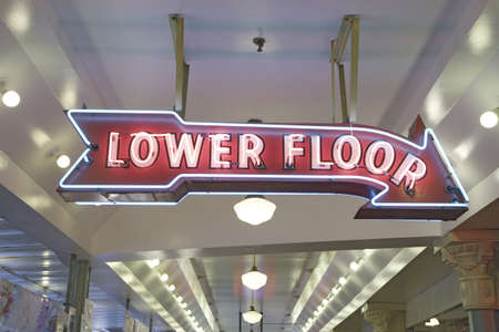 Pike Place Fish Market, in downtown Seattle, Washington displaying Lower Flow neon sign in interior view of the fish marketのeditorial素材