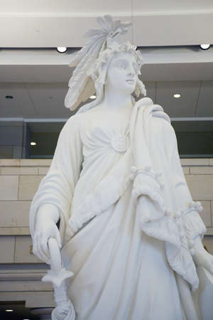 Students visiting U.S. Capitol look down on statue of Statue of Freedom at the U.S. Capitol Visitors Center, Washington, D.C.のeditorial素材