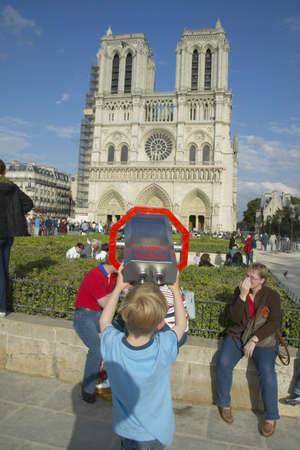 Boy at binoculars looking at Notre Dame Cathedral, Paris, Franceのeditorial素材