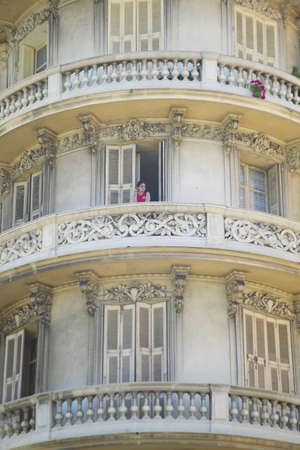 Girl smoking cigarette on balcony of apartment, Nice, Franceのeditorial素材