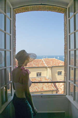 Woman looking out of the Picasso Museum, Antibes, Franceのeditorial素材