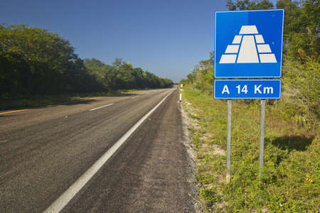 Road sign on Toll Road 180 in Yucatan Peninsula, Mexico to the Mayan Pyramid of Kukulkan (also known as El Castillo) at Chichen Itzaの写真素材