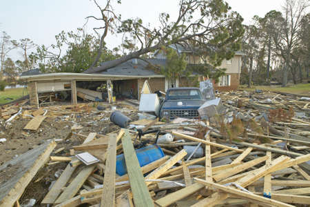 Fallen tree and debris in front of house heavily hit by Hurricane Ivan in Pensacola Florida