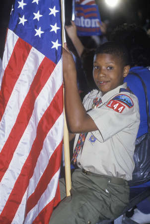 Boy Scout with an American flag at the Clinton/Gore 1992 Buscapade campaign tour in Tyler, Texas のeditorial素材