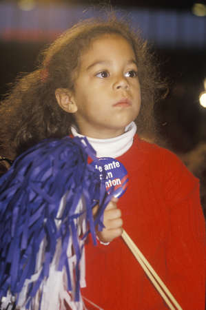 Little girl holds pom pom at a Denver campaign rally in 1992, Bill Clinton's final day of campaigning in Denver, Coloradoのeditorial素材