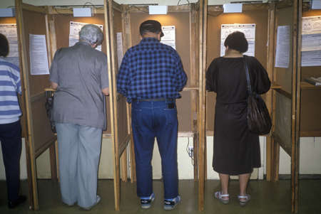 Voters and voting booths in a polling place, CA