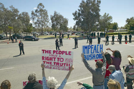 Presidential Motorcade with President George W. Bush past anti-Bush political rally with signs that read Impeach Bush in Tucson, AZのeditorial素材