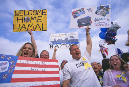 Family and friends cheering at a sailor's homecomingのeditorial素材