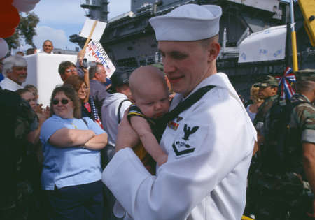 American Sailor Holding Baby After Returning Home From Sea, San Diego, Californiaのeditorial素材