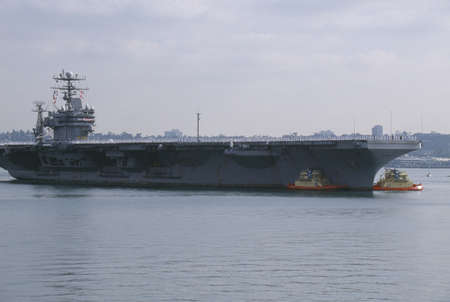 United States Aircraft Carrier Being Towed Into Harborのeditorial素材