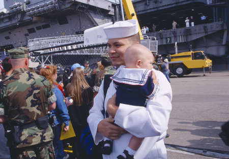 American Sailor Holding Baby After Returning Home From Seaのeditorial素材