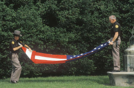 Two Officers Folding the American Flag, Charlottesville, Virginiaのeditorial素材