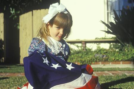 Little Girl Wrapped in American Flag, United States                                    のeditorial素材