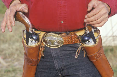 Old West gunslinger drawing guns during historical reenactment, CAのeditorial素材