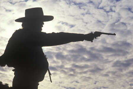 Silhouette of Cowboy aiming pistolのeditorial素材