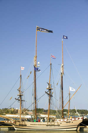 Tallship with Virginia and British flags flying at historic Yorktown, Colonial National Historical...