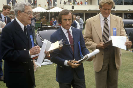 The Scottish race car driver Jackie Stewart, center, and other former racecar drivers judge classic cars at the 35th Annual Concours D' Elegance Competition, ca. 1985のeditorial素材