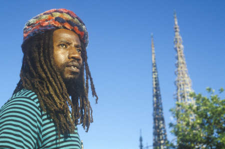 African American male poses with the Watts Towers, 20th Anniversary of the 1965 riots, Los Angeles, Californiaのeditorial素材