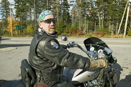 Motorcycle Harley driver looks into camera, Acadia National Park, Maine
