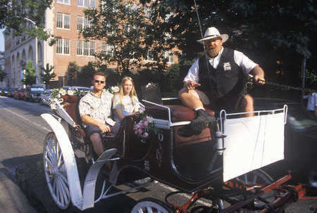 Horse and carriage riding in historic district of old Philadelphia, PA, home of Ben Franklin and...