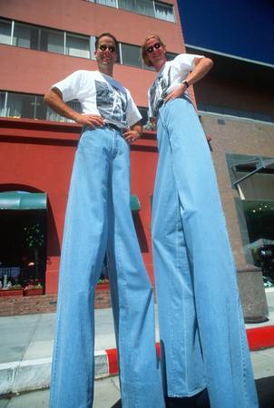 Couple on stilts at a car festival, Beverly Hills, CA