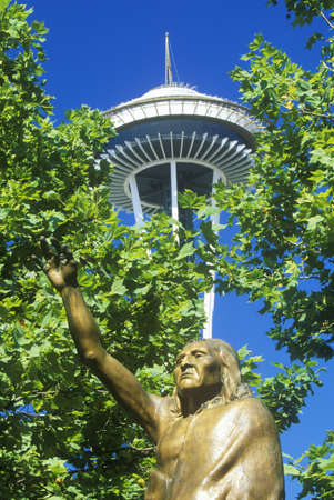 Space Needle with statue of Chief Seattle at base in Seattle, WA against blue skyのeditorial素材