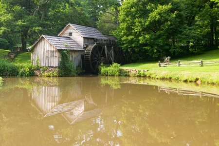 Historic Edwin B. Mabry Grist Mill (Mabry Mill) in rural Virginia on Blue Ridge Parkway and reflection on pond in summerのeditorial素材