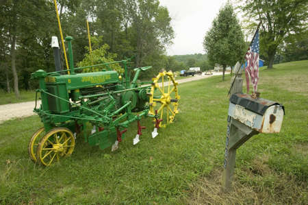 Antique John Deere tractor in front of yard along Manchester Road, Missouriのeditorial素材