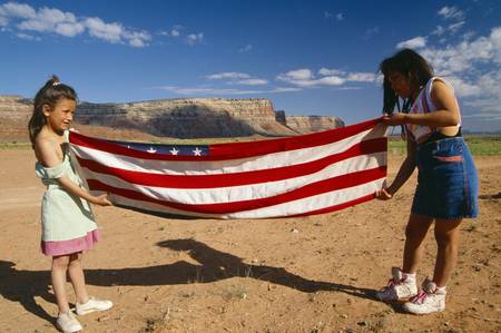 Two girls folding the American flag, Lee Ranch, UTのeditorial素材