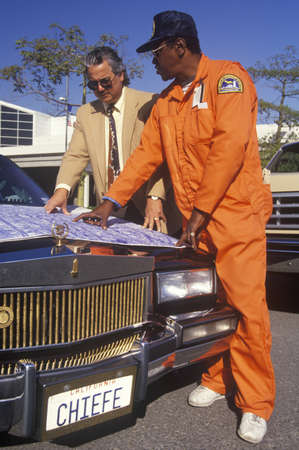 An architect reviewing the building plans with his foremanのeditorial素材