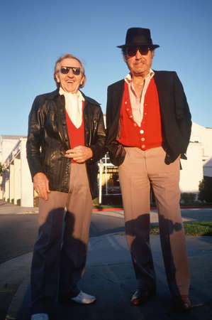 Two men in red vests taking a walk in Santa Monica, CAのeditorial素材