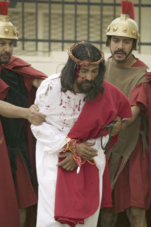 An actor portraying Jesus Christ being brought to trial on Good Friday, Easter, during the Passion play, a dramatic reenactment of the trial, torture and death of Jesus Christ at Christ the King Church and Our Lady of Guadalupe Parish, Oxnard, California,のeditorial素材