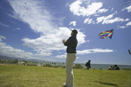 A man flying a kite in a deep blue sky on April 15, 2007, at the Santa Barbara Kite Festival, Santa Barbara City College, overlooking Pacific Ocean.のeditorial素材