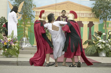 An actor portraying Jesus Christ being brought to trial before Pontius Pilate on Good Friday, Easter, during the Passion play, a dramatic reenactment of the trial, torture and death of Jesus Christ at Christ the King Church and Our Lady of Guadalupe Parisのeditorial素材