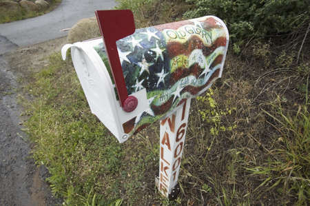 Patriotic mailbox decorated with Old Glory displaying it's red flag up, alongside a road near Ojai California on Route 33のeditorial素材
