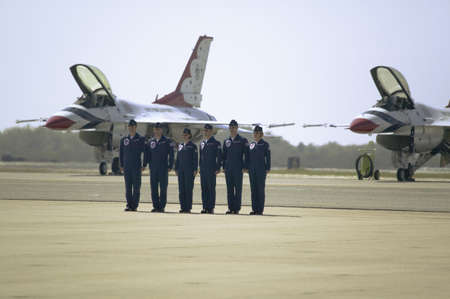Six US Air Force male and female pilots standing at attention in front of their F-16C Fighting Falcons, known as the Thunderbirds before flying at the 42nd Naval Base Ventura County (NBVC) Air Show at Point Mugu, Ventura County, Southern California.のeditorial素材