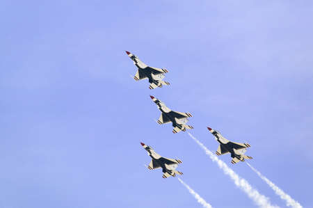 Four US Air Force F-16C Fighting Falcons, known as the Thunderbirds, flying in formation with white trailer of smoke over the 42nd Naval Base Ventura County (NBVC) Air Show at Point Mugu, Ventura County, Southern California.のeditorial素材