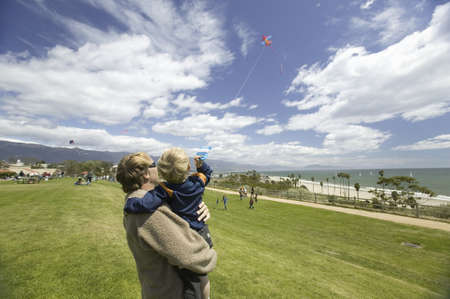 Father and son flying a kite in a deep blue sky on April 15, 2007, at the Santa Barbara Kite Festival, Santa Barbara City College, overlooking Pacific Ocean.のeditorial素材